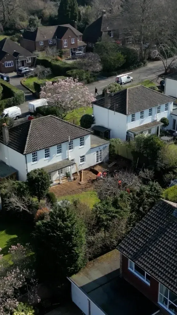 Aerial view of a Surrey home renovation with groundworks underway